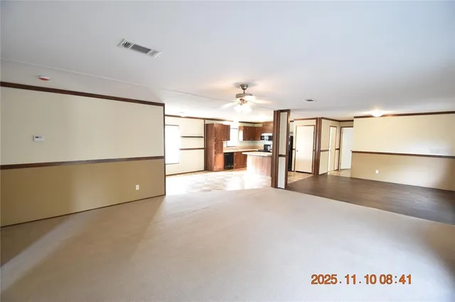 a view of a kitchen with a refrigerator and a sink