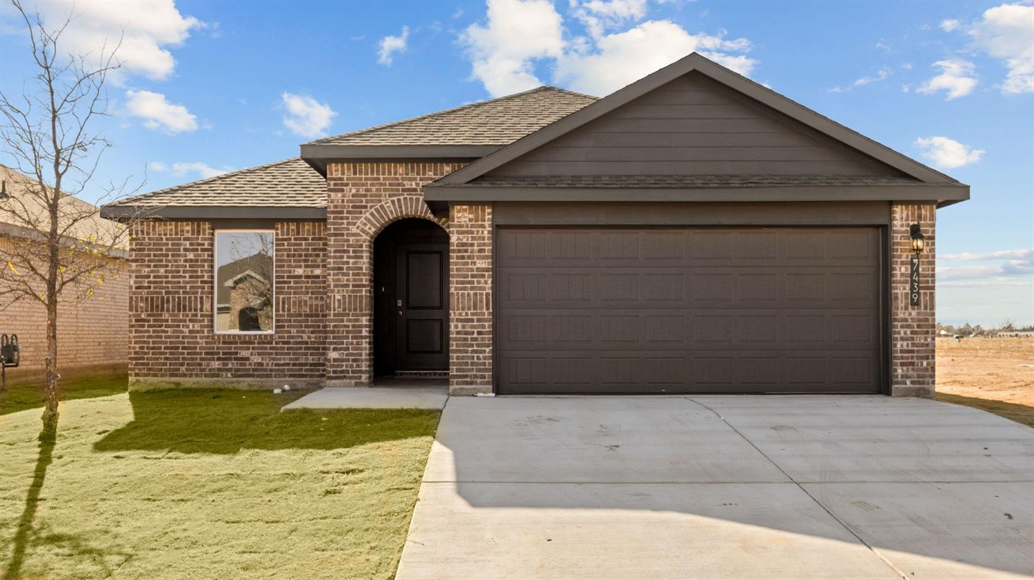 7448 8th Street Lubbock, TX 79416 - Photo 1 of 22 a front view of a house with garage