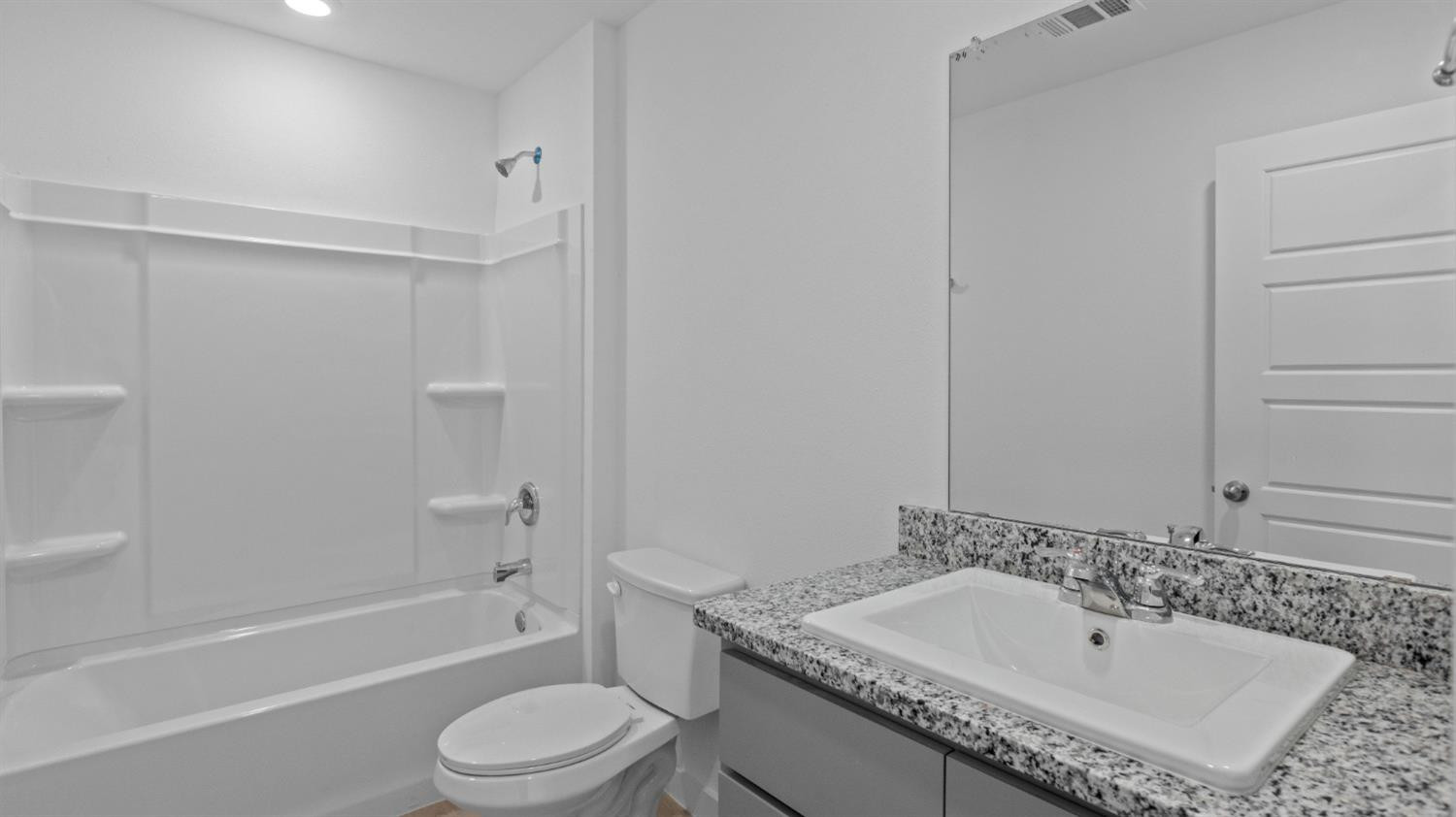 7448 8th Street Lubbock, TX 79416 - Photo 13 of 22 a bathroom with a granite countertop sink toilet and shower