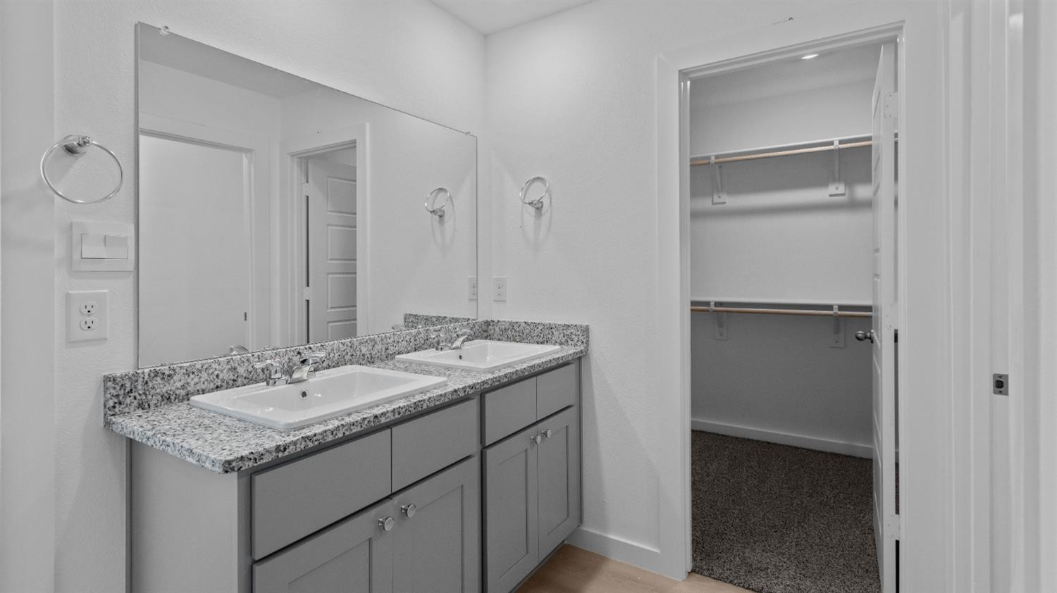 7448 8th Street Lubbock, TX 79416 - Photo 17 of 22 a bathroom with a granite countertop sink and a mirror