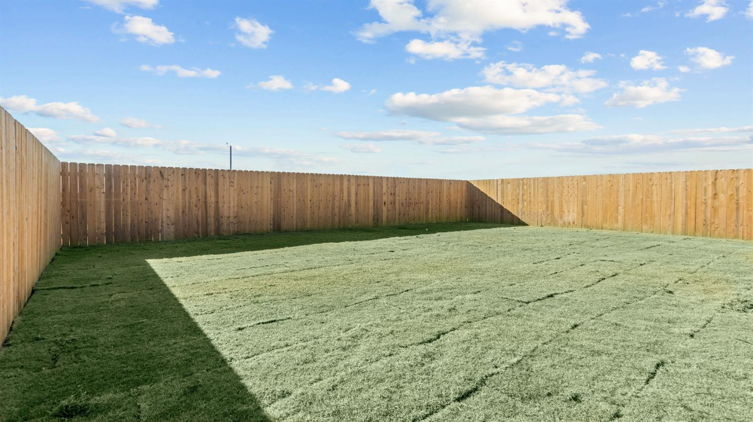 7448 8th Street Lubbock, TX 79416 - Photo 22 of 22 a view of backyard with wooden fence