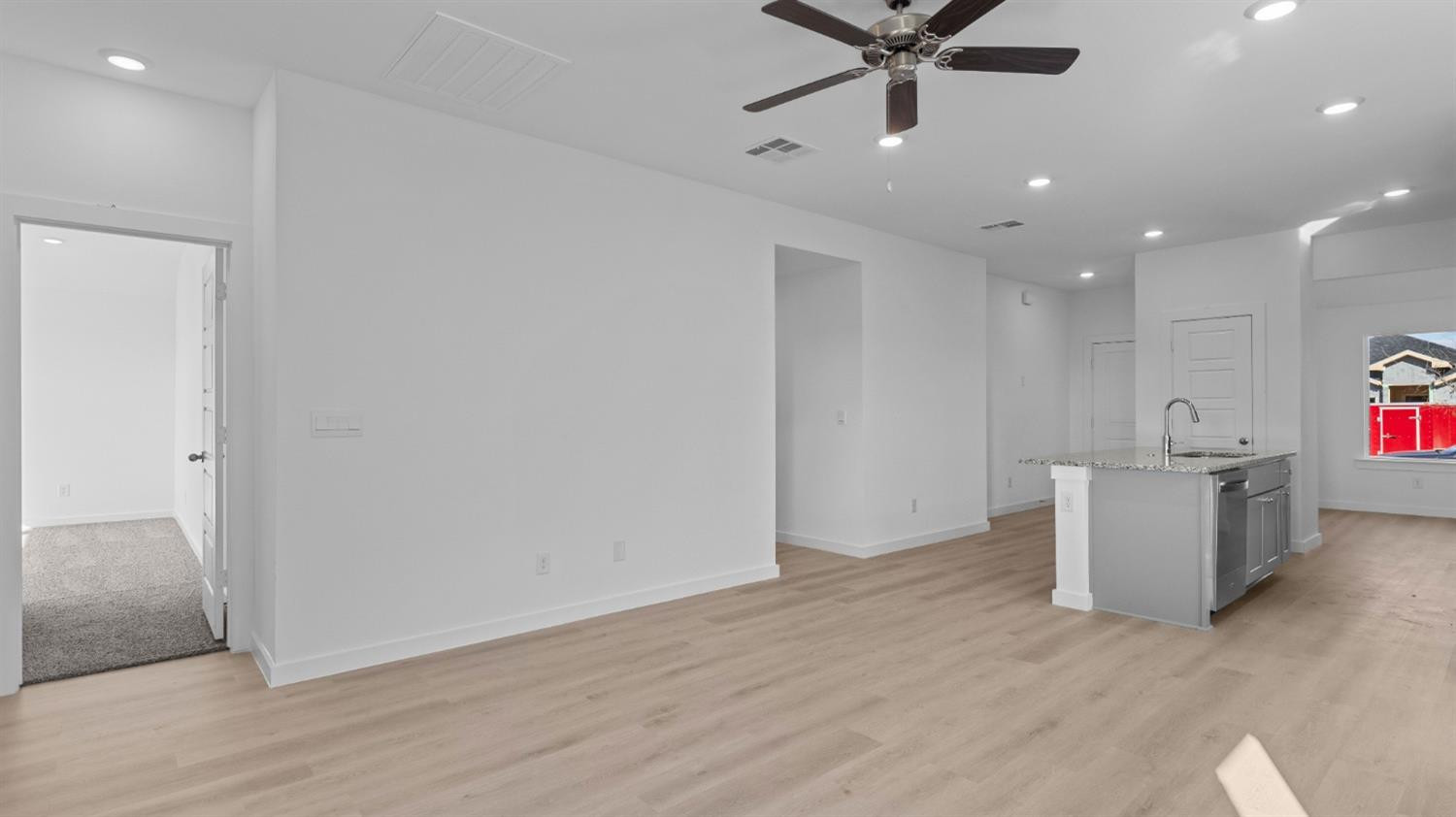 7448 8th Street Lubbock, TX 79416 - Photo 6 of 22 an empty room with wooden floor and windows
