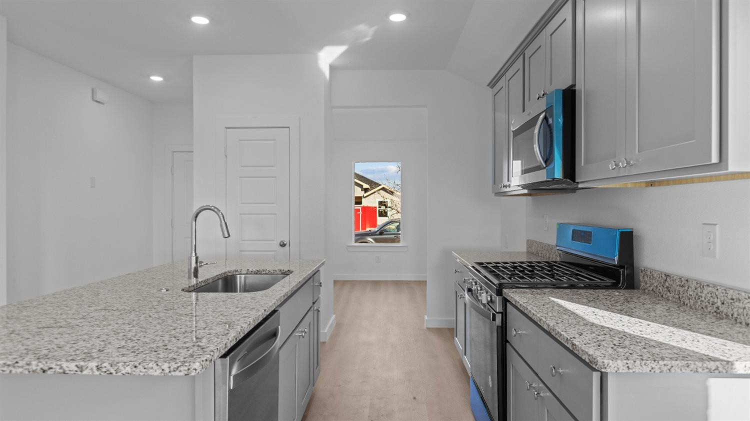 7448 8th Street Lubbock, TX 79416 - Photo 9 of 22 a kitchen with stainless steel appliances granite countertop a sink stove and cabinets
