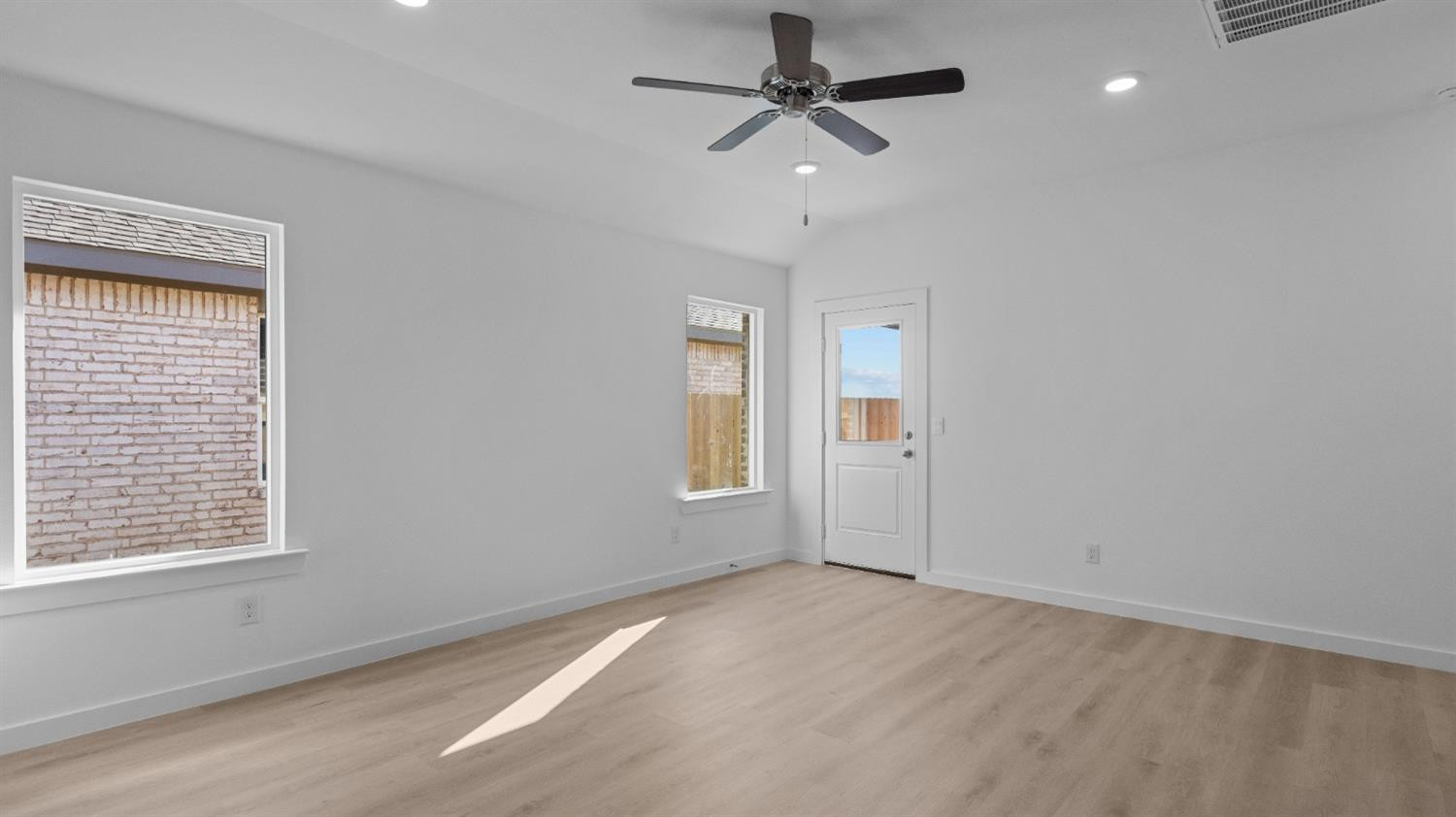 7448 8th Street Lubbock, TX 79416 - Photo 10 of 22 a view of a livingroom with a ceiling fan and window
