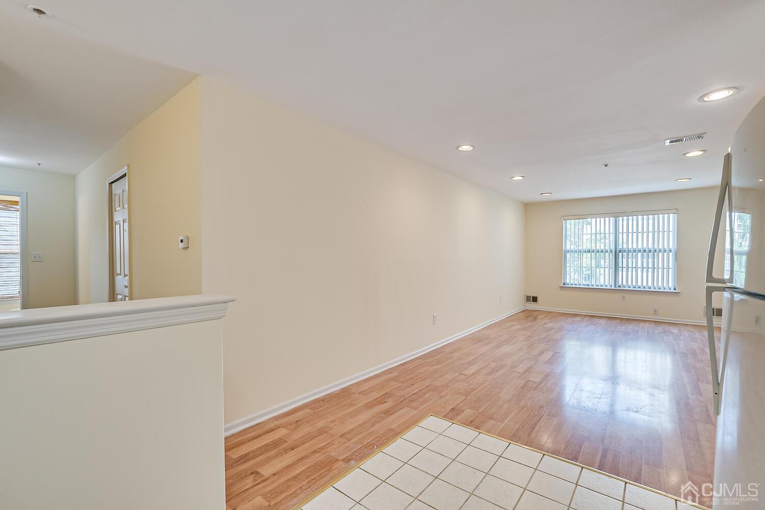 22 Prestwick Way Edison, NJ 08820 - Photo 11 of 24 an empty room with wooden floor and windows