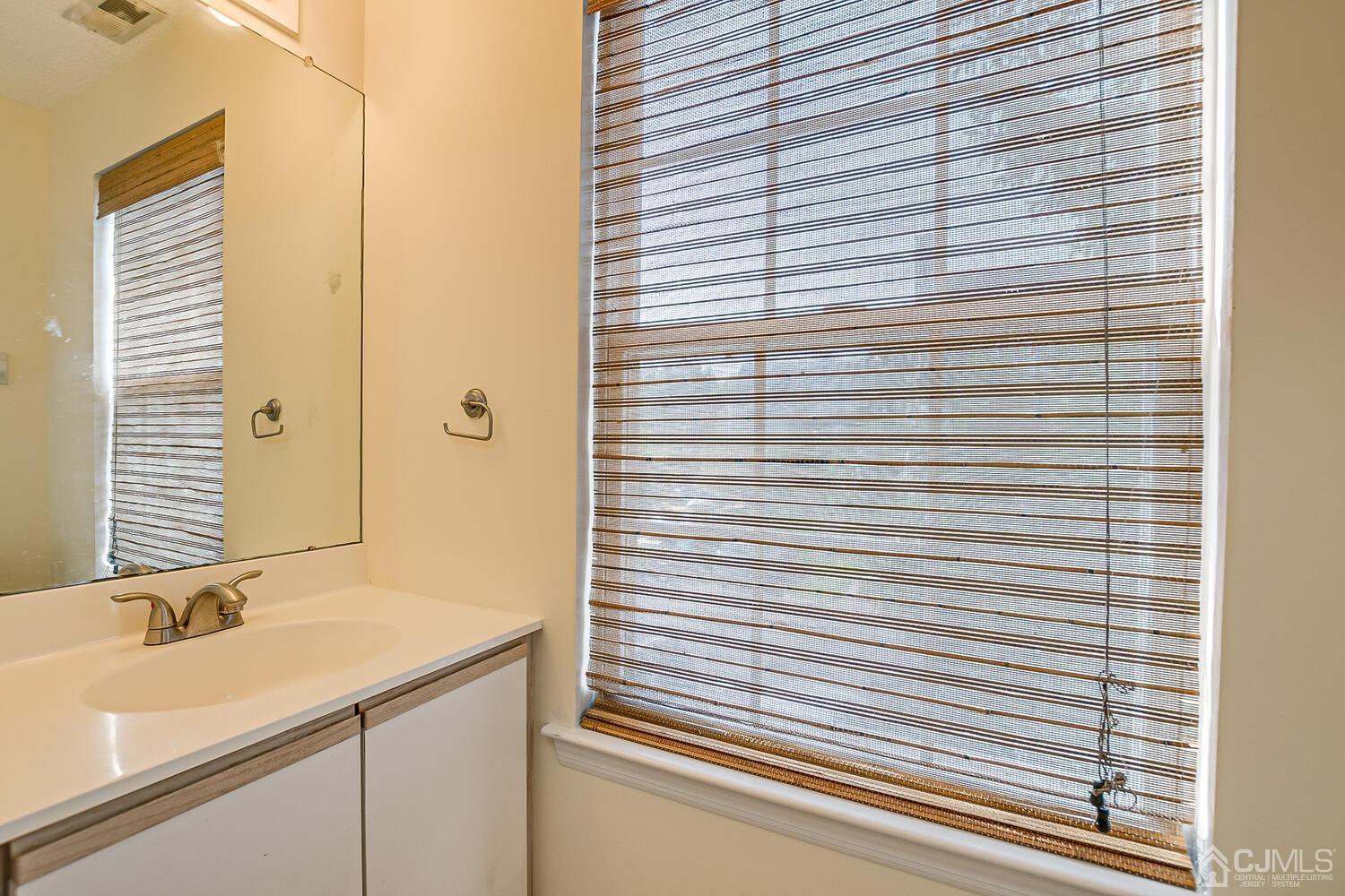 22 Prestwick Way Edison, NJ 08820 - Photo 12 of 24 a bathroom with a sink and a mirror