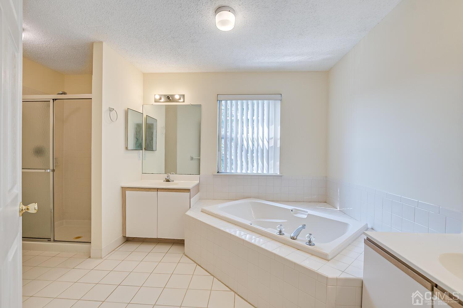 22 Prestwick Way Edison, NJ 08820 - Photo 18 of 24 a bathroom with a tub a sink and a window