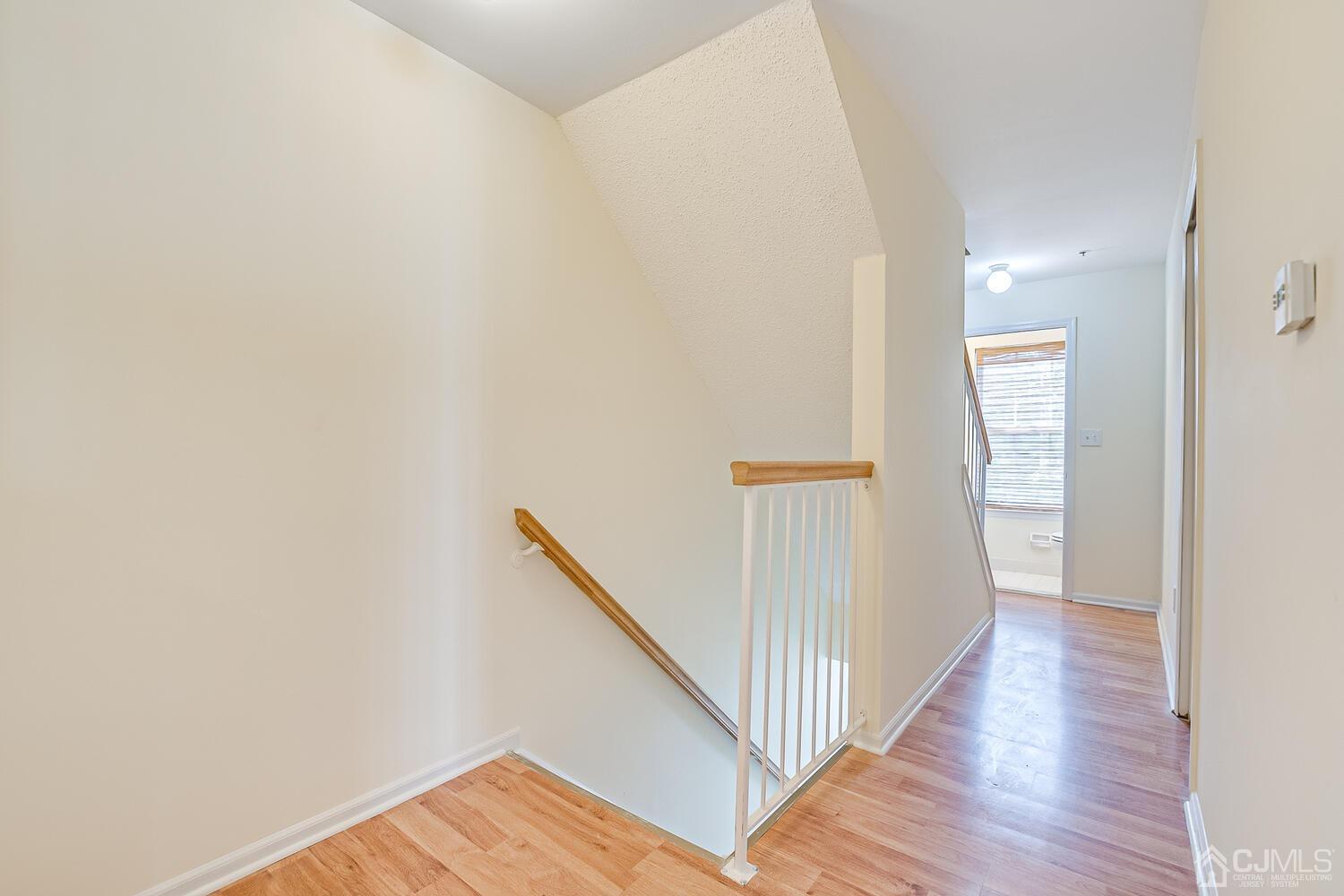 22 Prestwick Way Edison, NJ 08820 - Photo 5 of 24 a view of a hallway with wooden floor