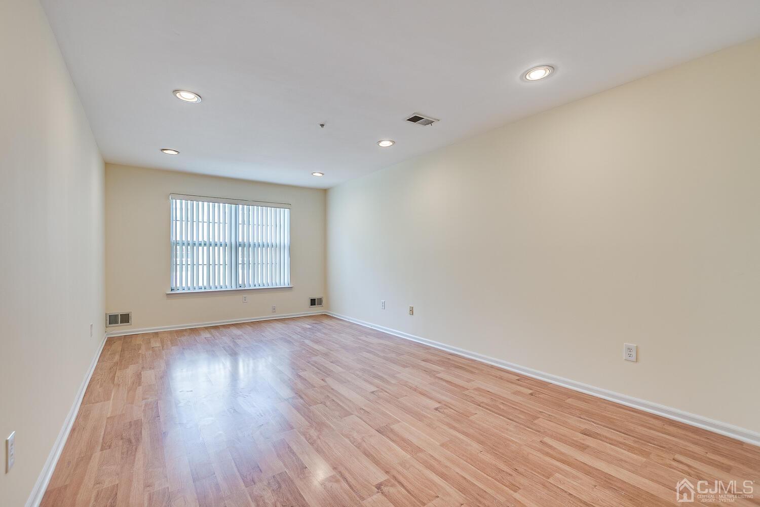 22 Prestwick Way Edison, NJ 08820 - Photo 7 of 24 wooden floor in an empty room with a window