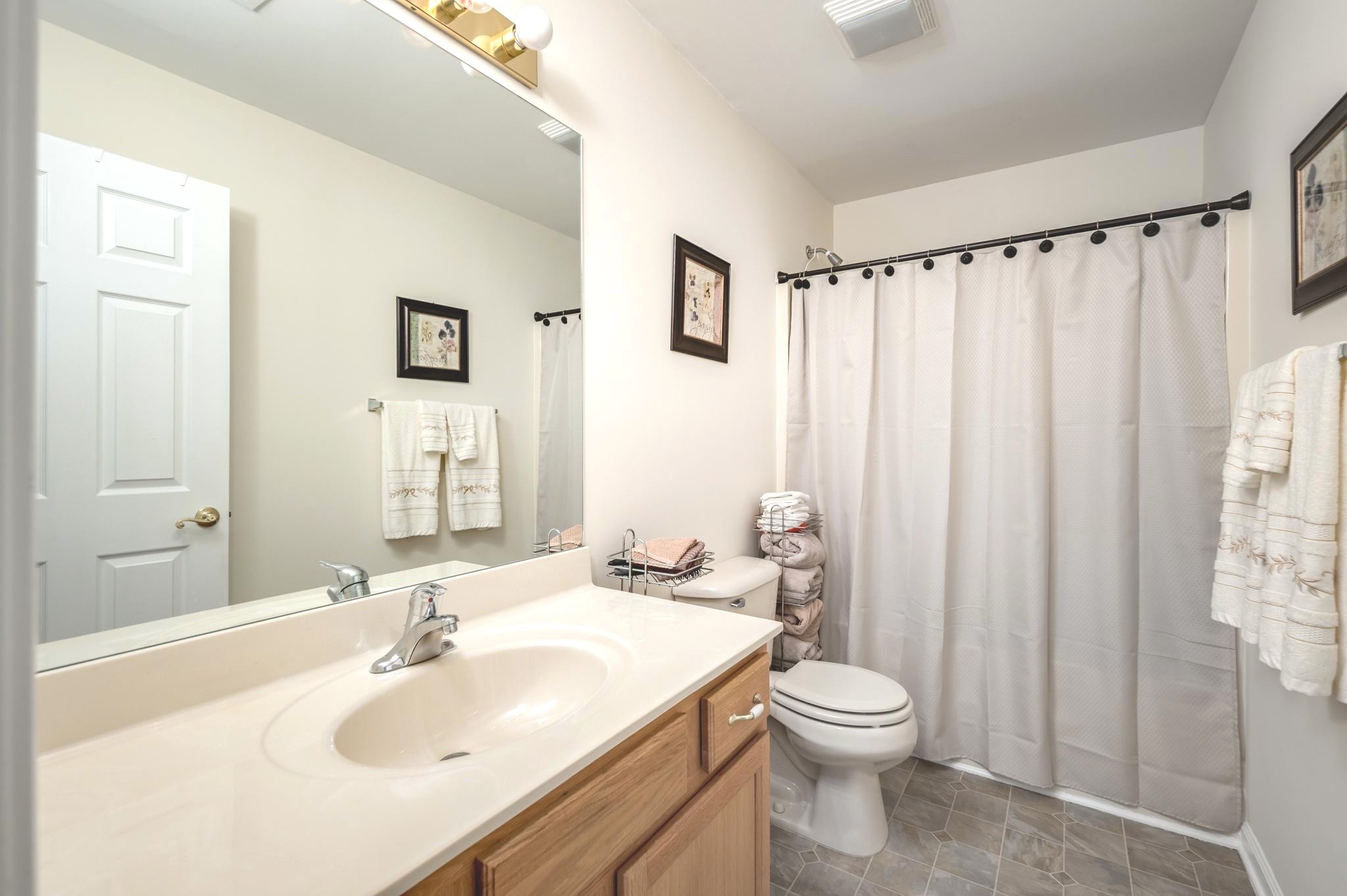 2901 Buckner Lane Spring Hill, TN 37174 - Photo 24 of 28 a bathroom with a toilet a sink and a mirror
