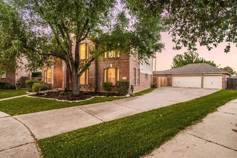 a front view of a house with a yard and pathway