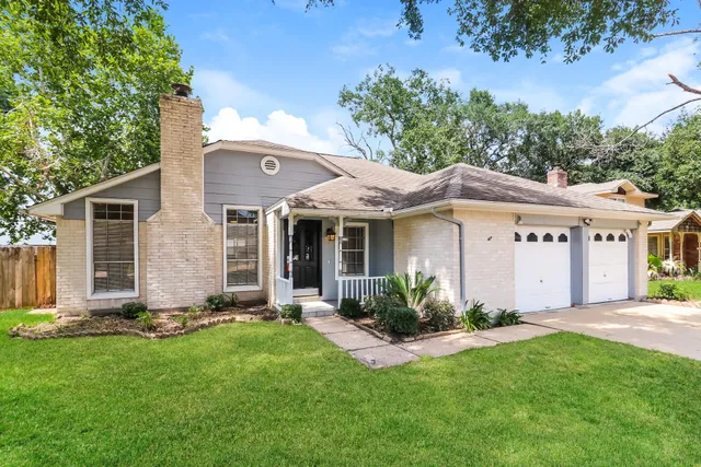 a front view of a house with a yard and porch