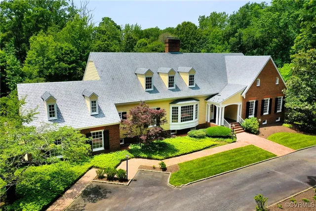 an aerial view of a house with a yard table and chairs