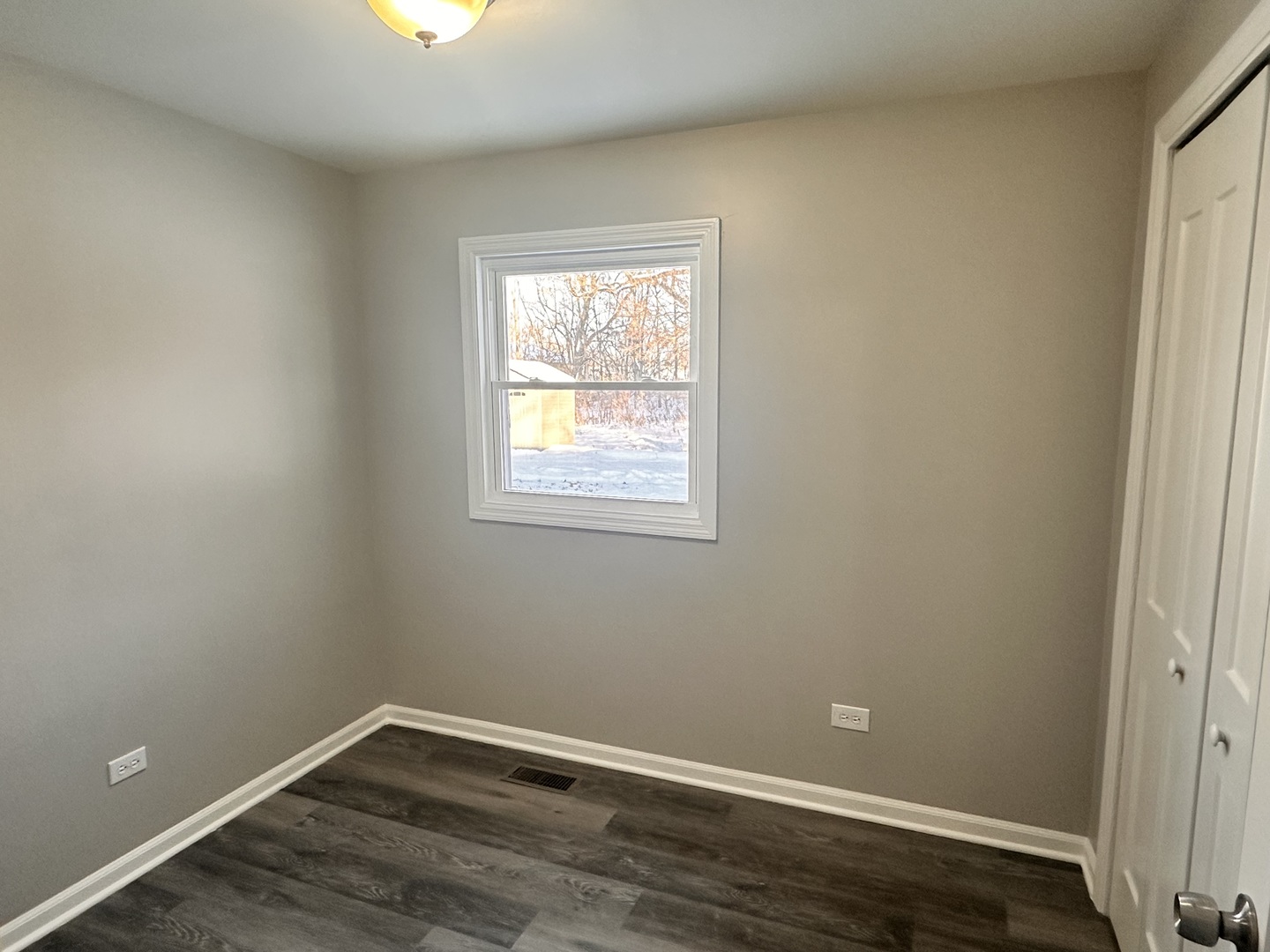 518 Spring Street Streator, IL 61364 - Photo 12 of 17 a view of an empty room with wooden floor and a window