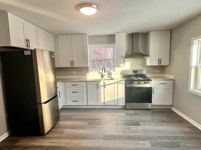 a kitchen with stainless steel appliances a refrigerator stove and sink
