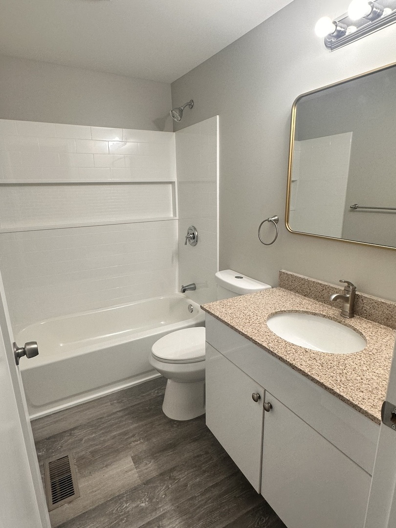 518 Spring Street Streator, IL 61364 - Photo 8 of 17 a bathroom with a granite countertop toilet sink and mirror
