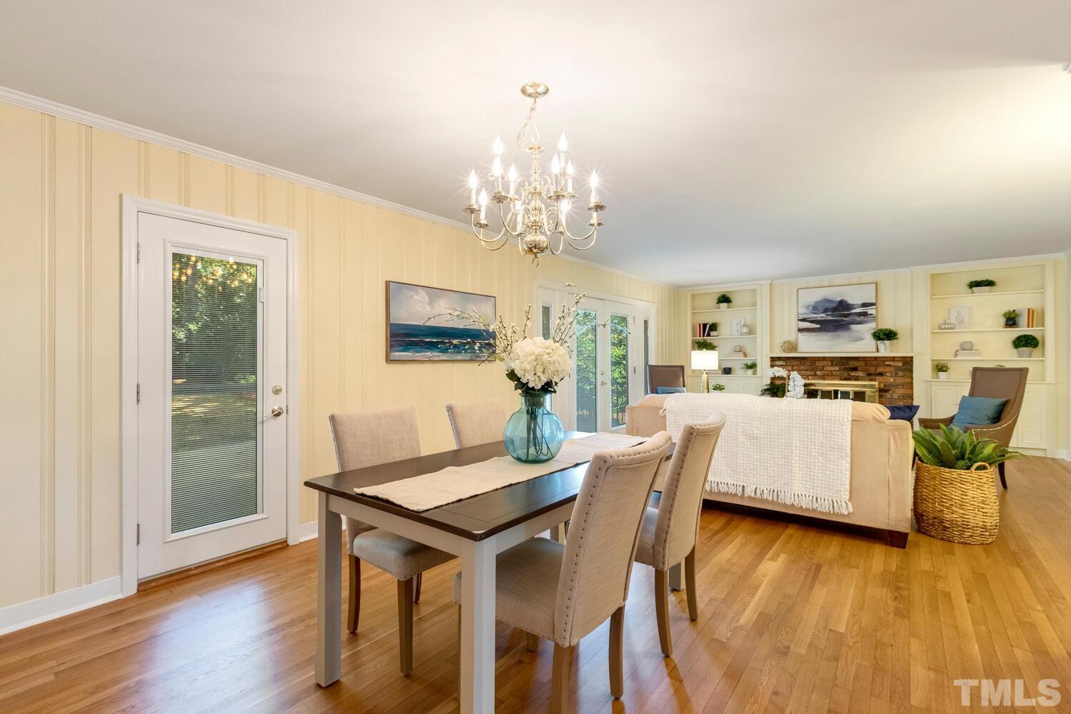 5004 Rembert Drive Raleigh, NC 27612 - Photo 14 of 61 a living room with dining table and wooden floor