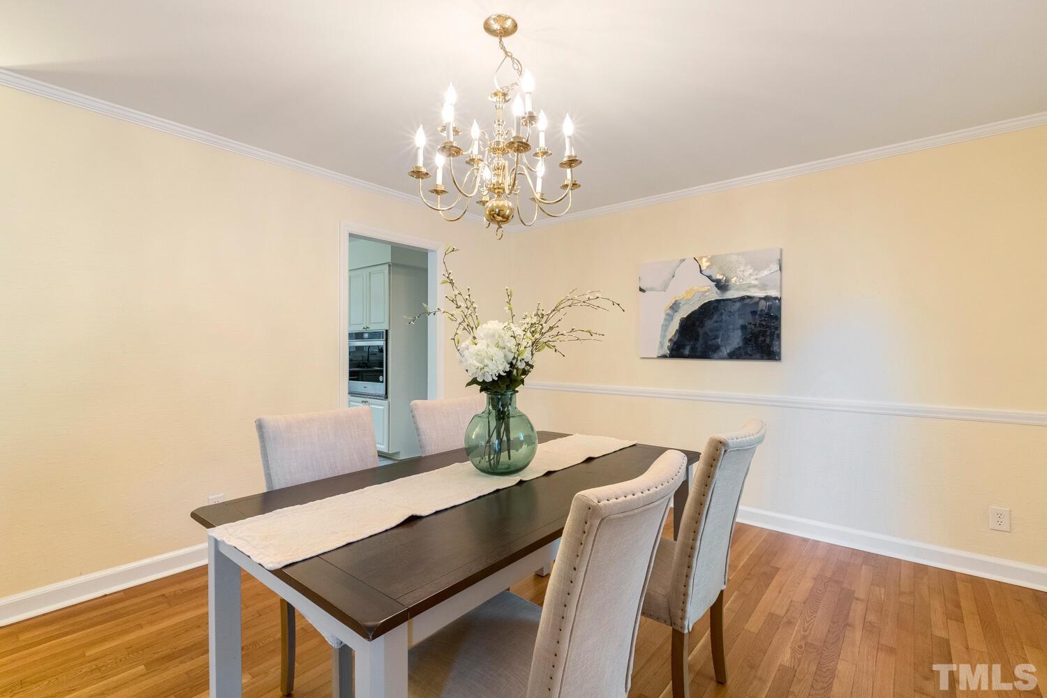 5004 Rembert Drive Raleigh, NC 27612 - Photo 15 of 61 a view of a dining room with furniture and chandelier