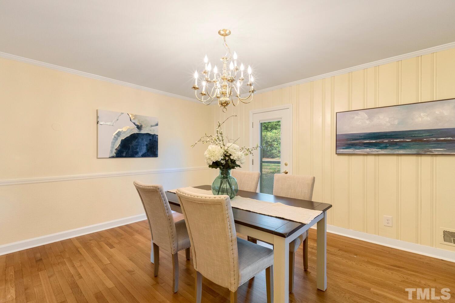 5004 Rembert Drive Raleigh, NC 27612 - Photo 16 of 61 a dining room with furniture and chandelier