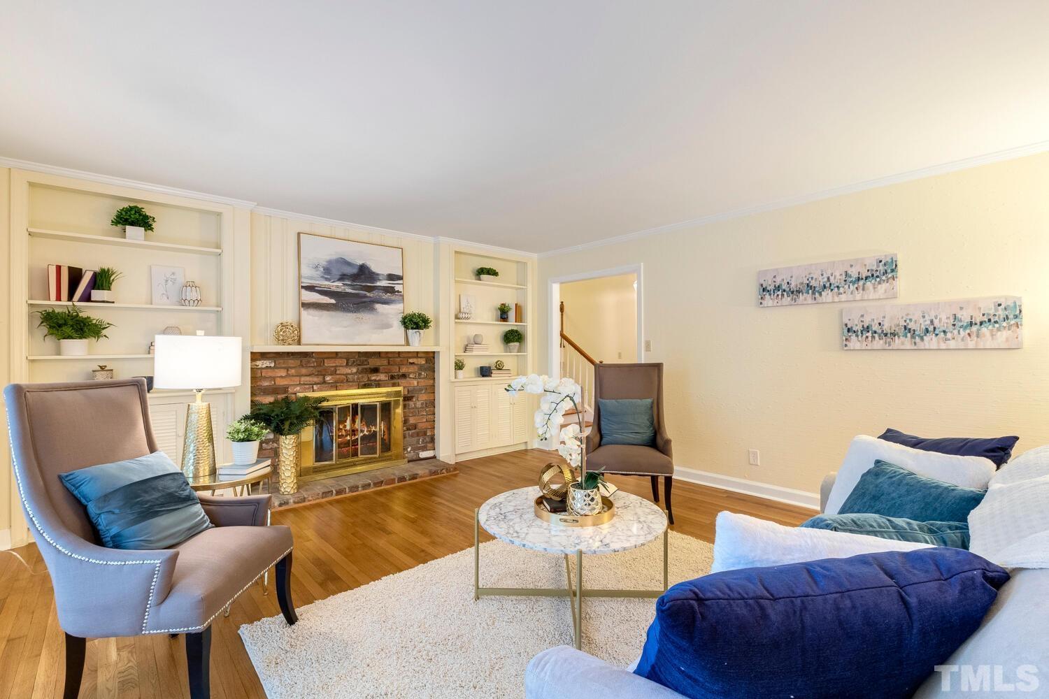 5004 Rembert Drive Raleigh, NC 27612 - Photo 19 of 61 a living room with furniture and a fireplace