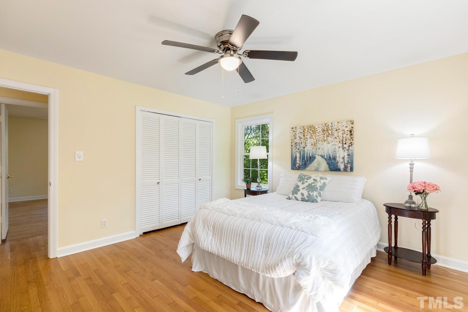 5004 Rembert Drive Raleigh, NC 27612 - Photo 23 of 61 a bedroom with a bed and a chandelier
