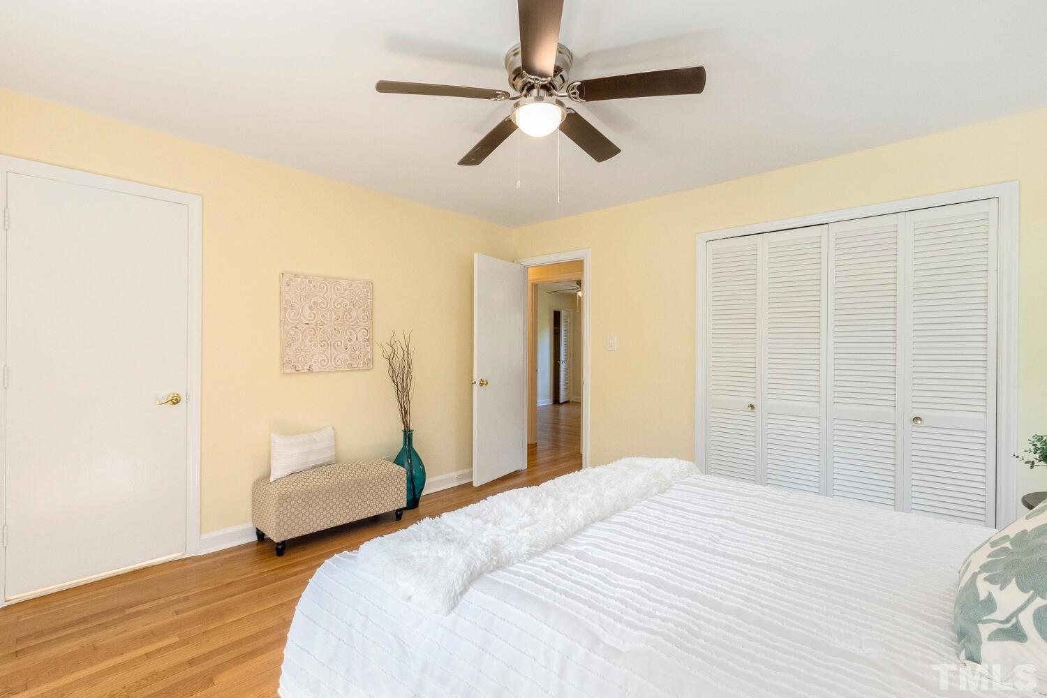 5004 Rembert Drive Raleigh, NC 27612 - Photo 25 of 61 a bedroom with a bed and a chandelier