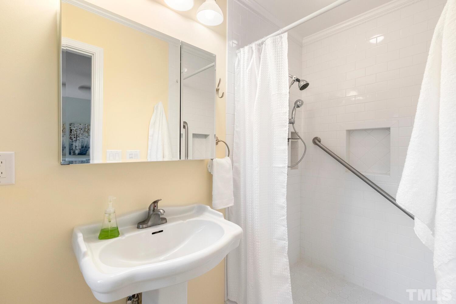 5004 Rembert Drive Raleigh, NC 27612 - Photo 26 of 61 a bathroom with a sink and a mirror
