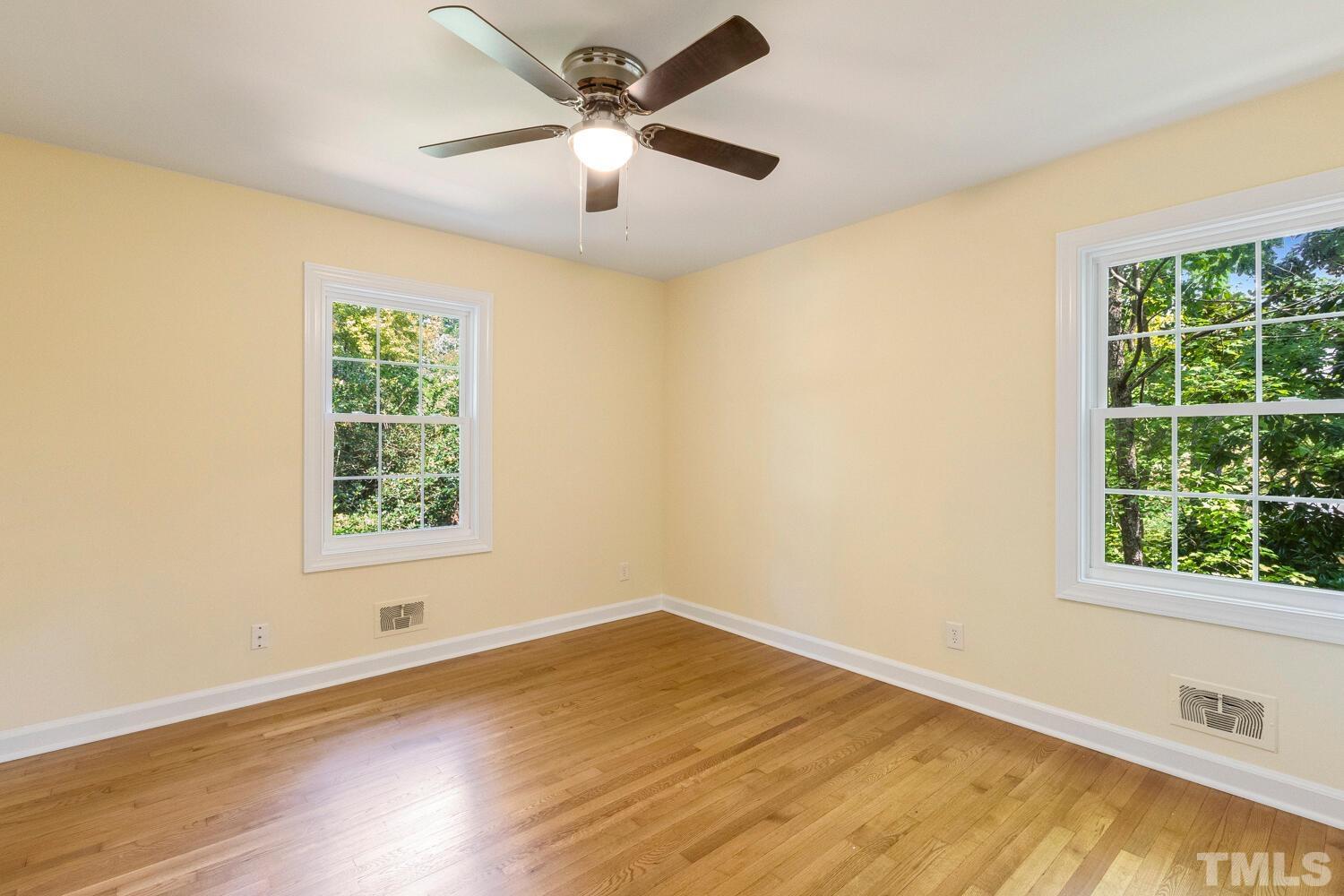 5004 Rembert Drive Raleigh, NC 27612 - Photo 28 of 61 a view of an empty room with wooden floor and a window