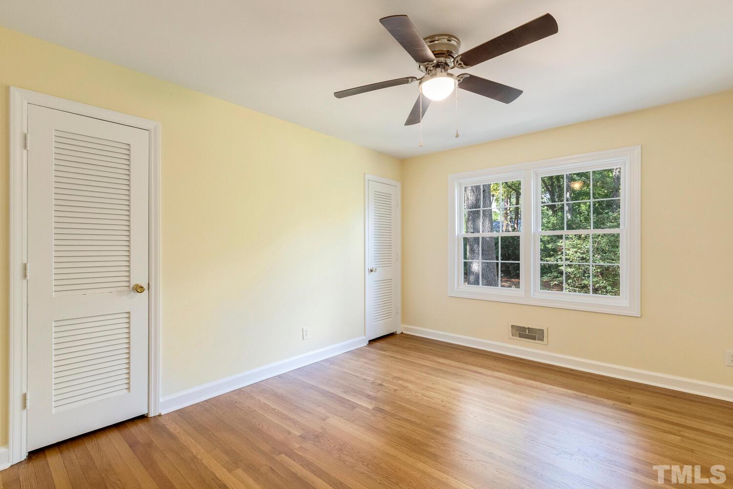 5004 Rembert Drive Raleigh, NC 27612 - Photo 29 of 61 a view of an empty room with wooden floor and a window