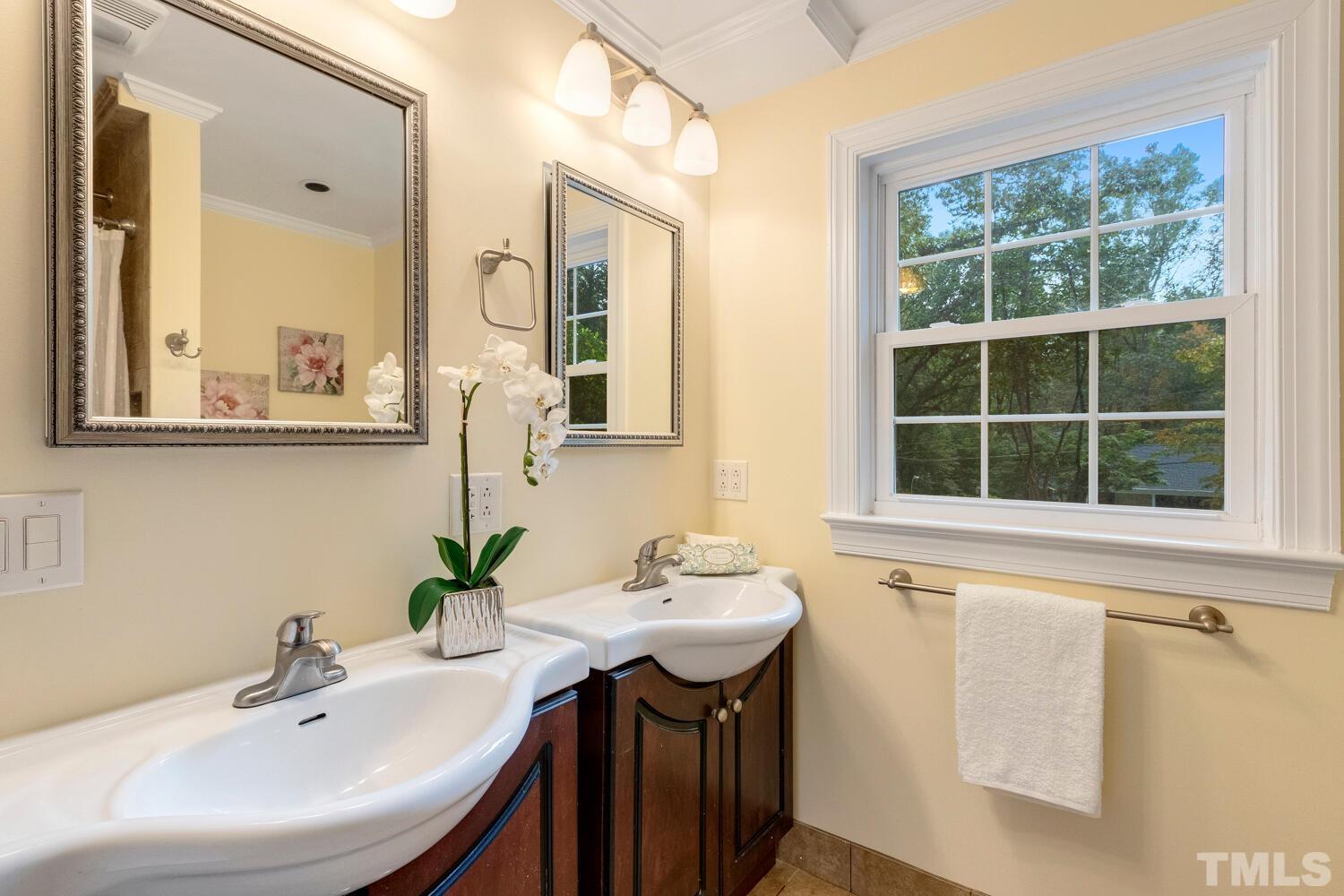 5004 Rembert Drive Raleigh, NC 27612 - Photo 39 of 61 a bathroom with a sink and a mirror