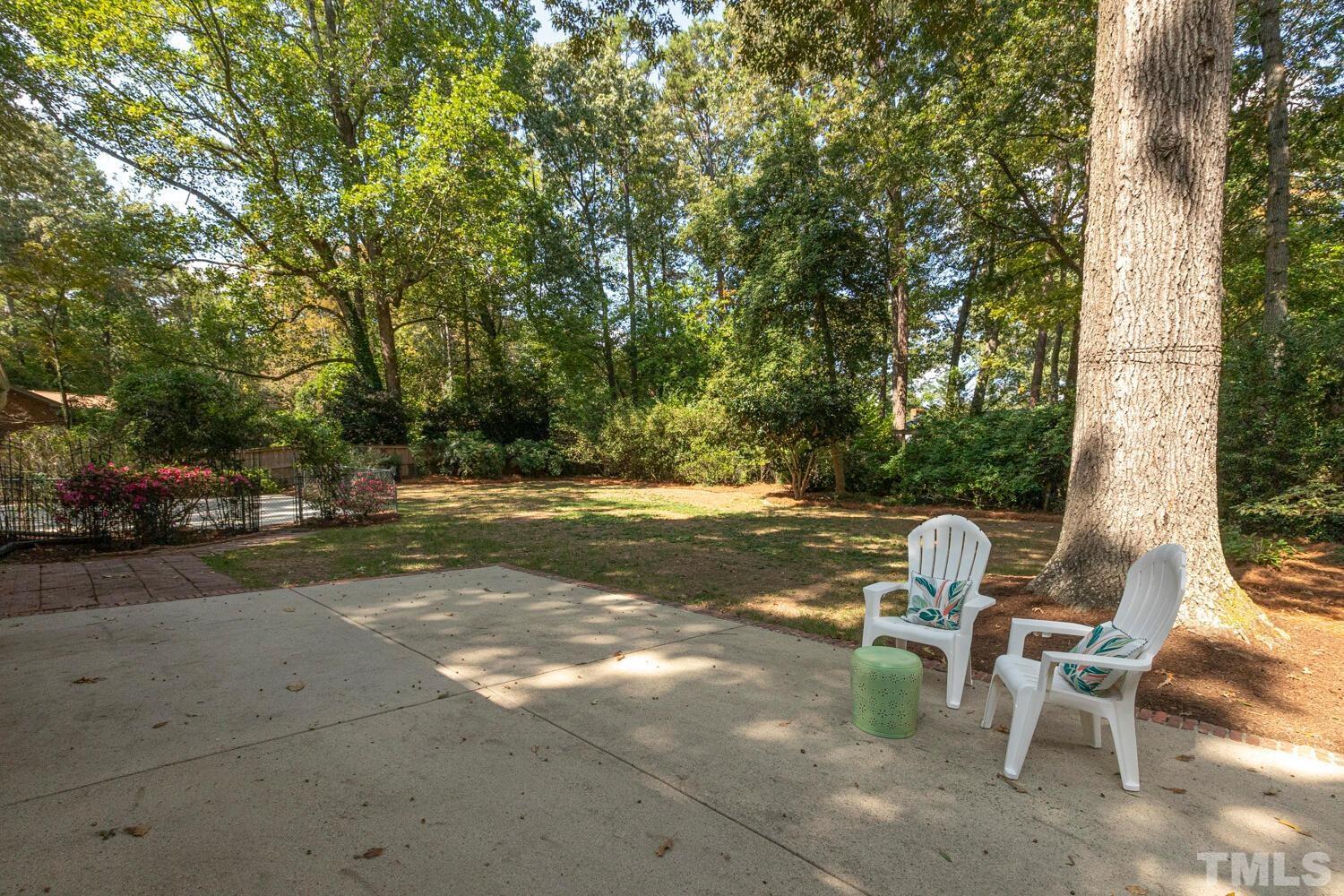 5004 Rembert Drive Raleigh, NC 27612 - Photo 51 of 61 a view of backyard with outdoor seating and trees