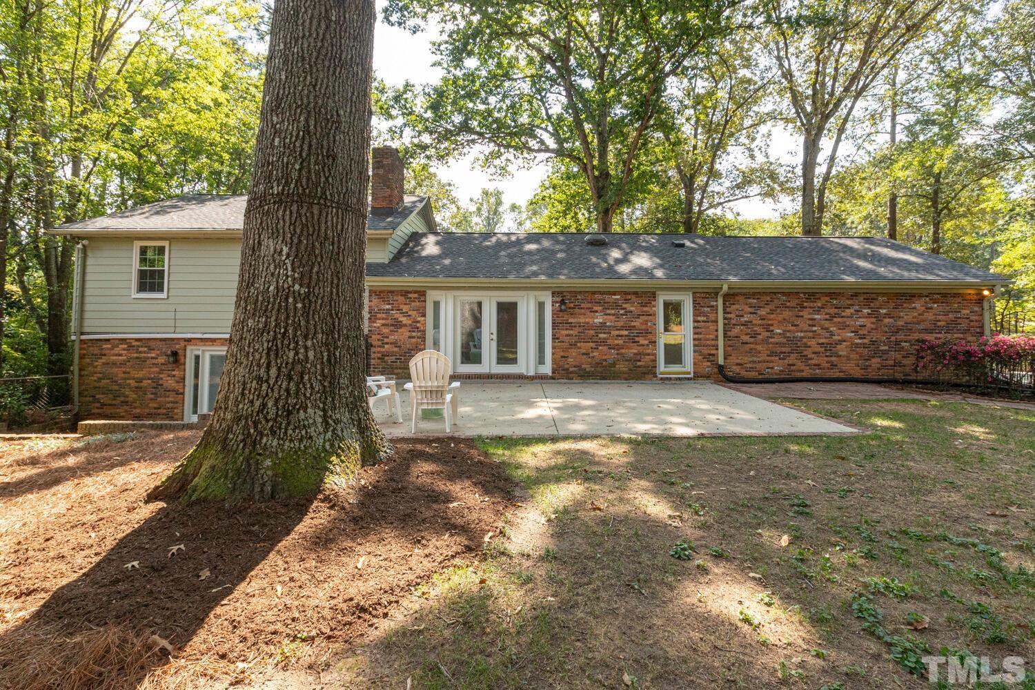 5004 Rembert Drive Raleigh, NC 27612 - Photo 53 of 61 a front view of a house with a garden and trees