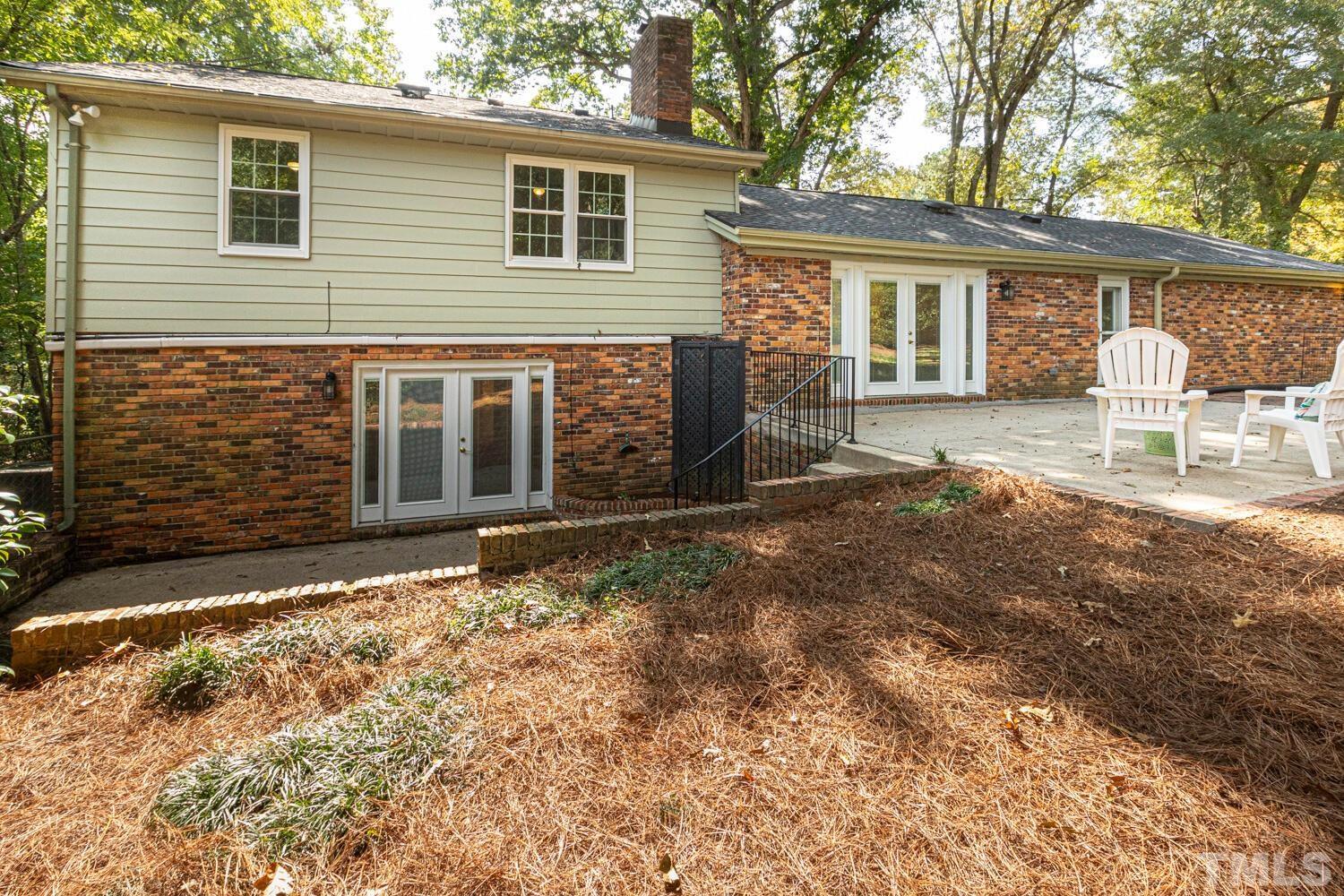 5004 Rembert Drive Raleigh, NC 27612 - Photo 59 of 61 a front view of a house with a yard and garage