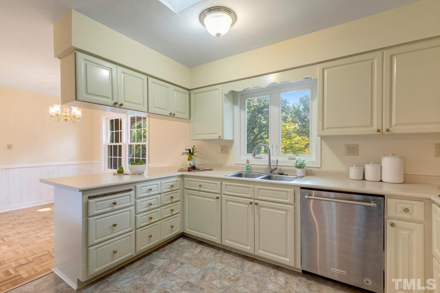 5004 Rembert Drive Raleigh, NC 27612 - Photo 6 of 61 a kitchen with a sink and cabinets