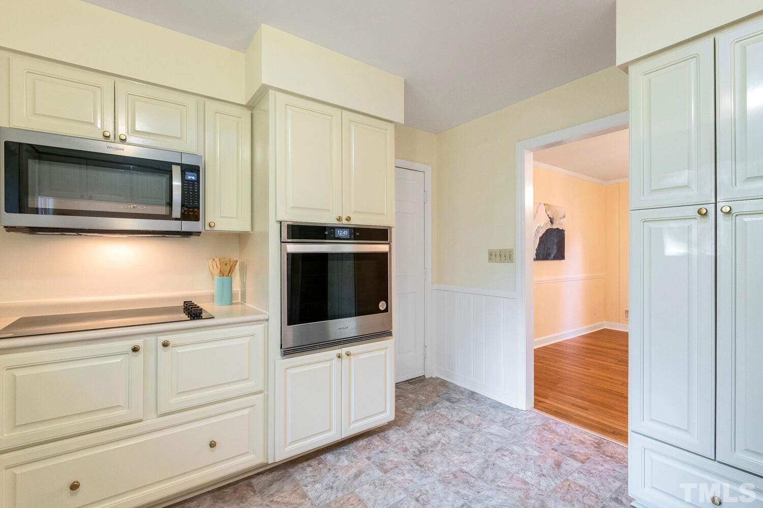5004 Rembert Drive Raleigh, NC 27612 - Photo 8 of 61 a kitchen with stainless steel appliances white cabinets and a stove