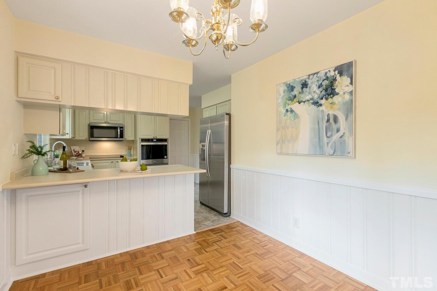 5004 Rembert Drive Raleigh, NC 27612 - Photo 9 of 61 a kitchen with stainless steel appliances a refrigerator and a sink