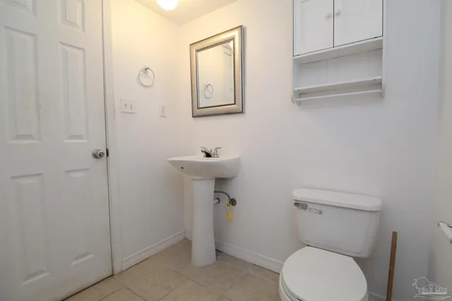 a white toilet sitting next to a bathroom sink