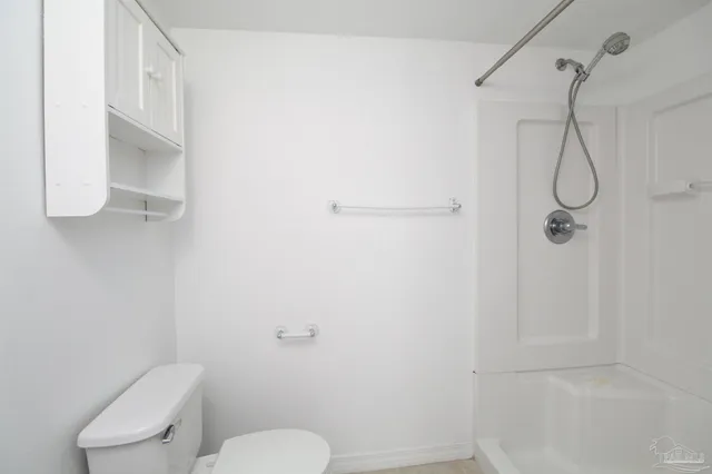 a bathroom with a toilet and a shower