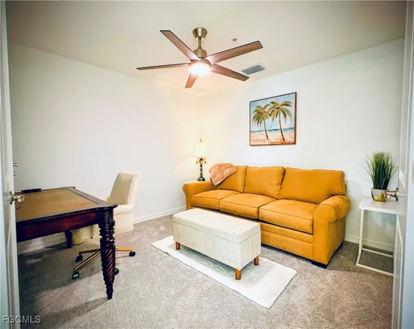 a blue couch sitting in a living room with a rug