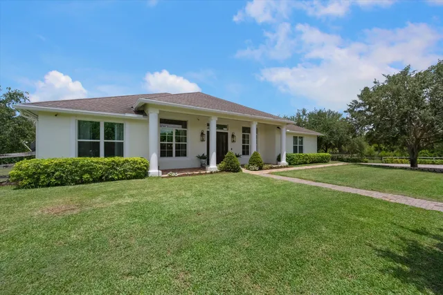 a living room with furniture a rug and a chandelier
