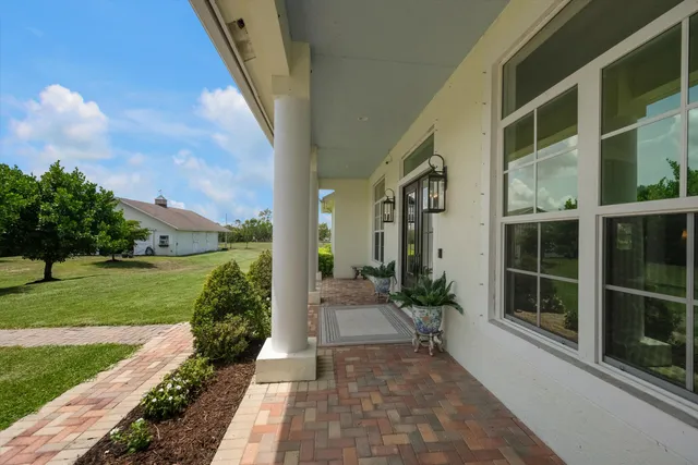 a kitchen with stainless steel appliances granite countertop a table chairs microwave and sink