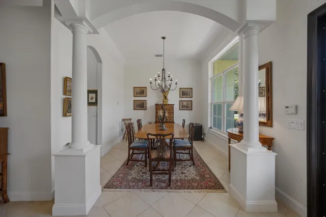 a bedroom with a bed a couch and a large window