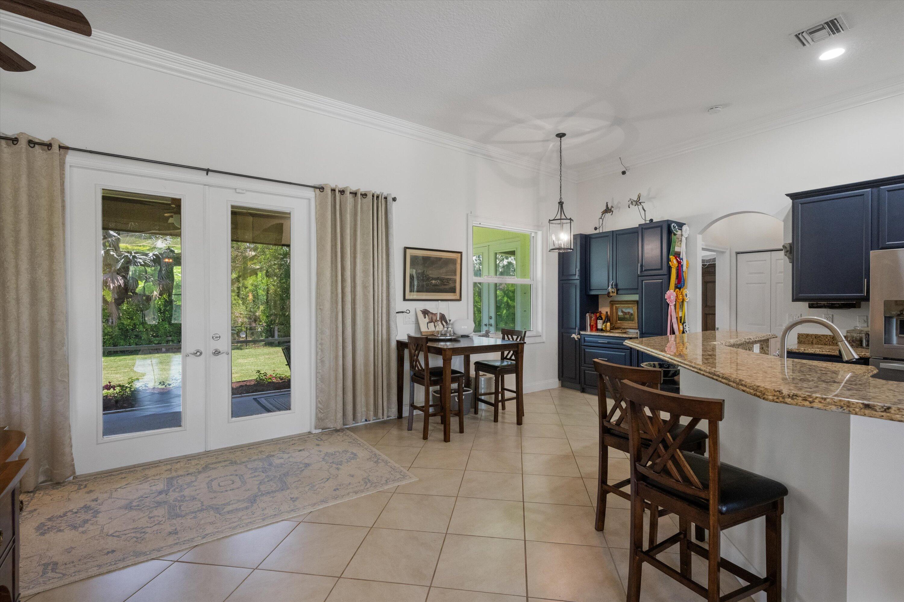 19986 Black Falcon Road Loxahatchee, FL 33470 - Photo 31 of 105 a view of a dining room with furniture window and outside view