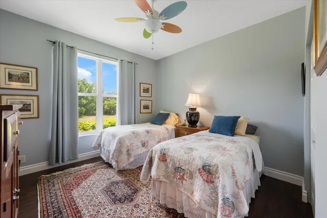 a bathroom with a granite countertop bathtub sink and mirror