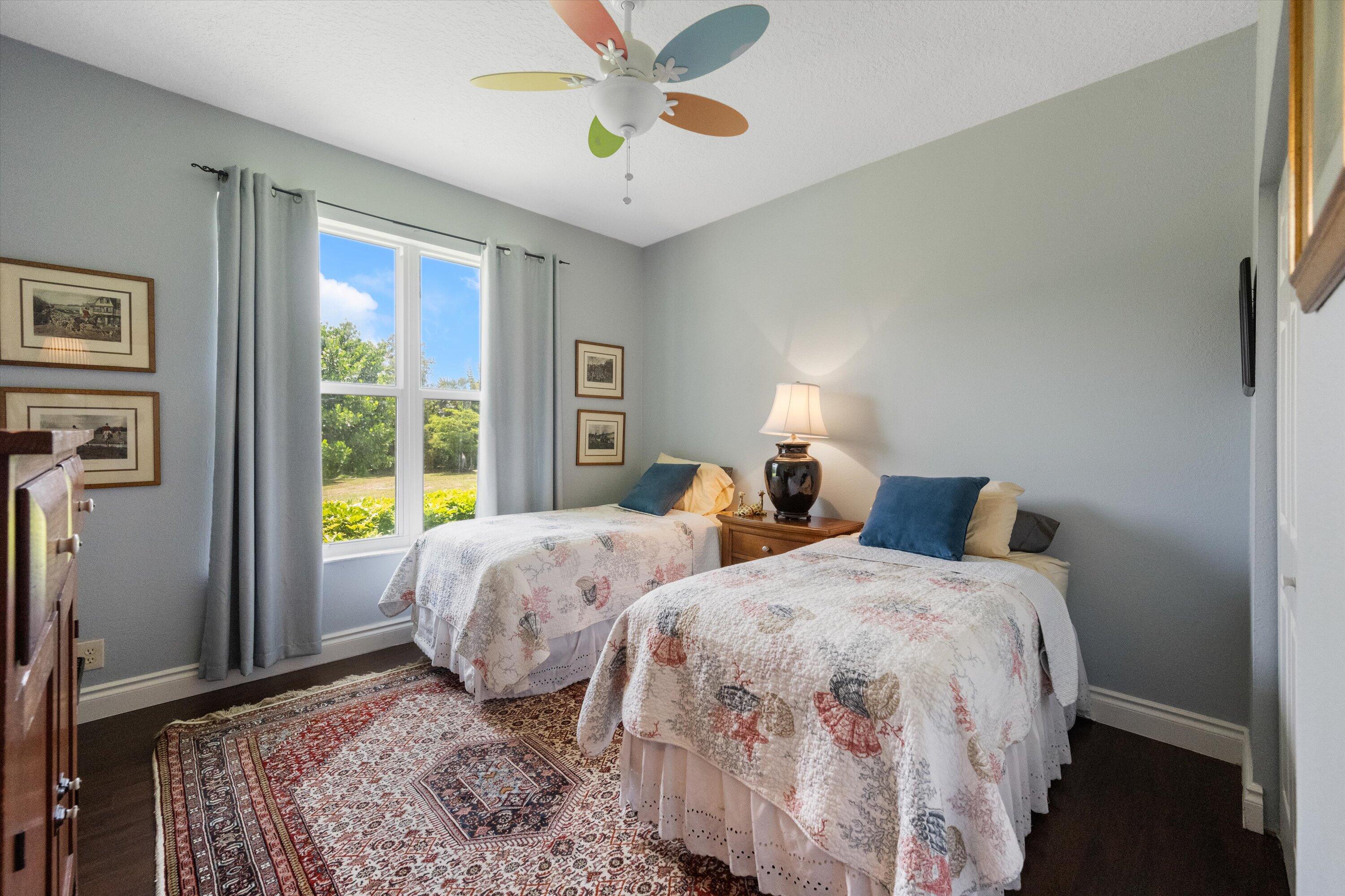 19986 Black Falcon Road Loxahatchee, FL 33470 - Photo 32 of 105 a bedroom with two beds and a window