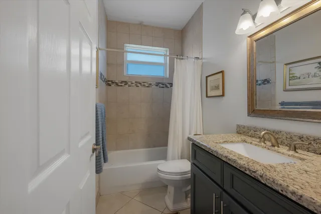 a view of a grassy field with trees in the background