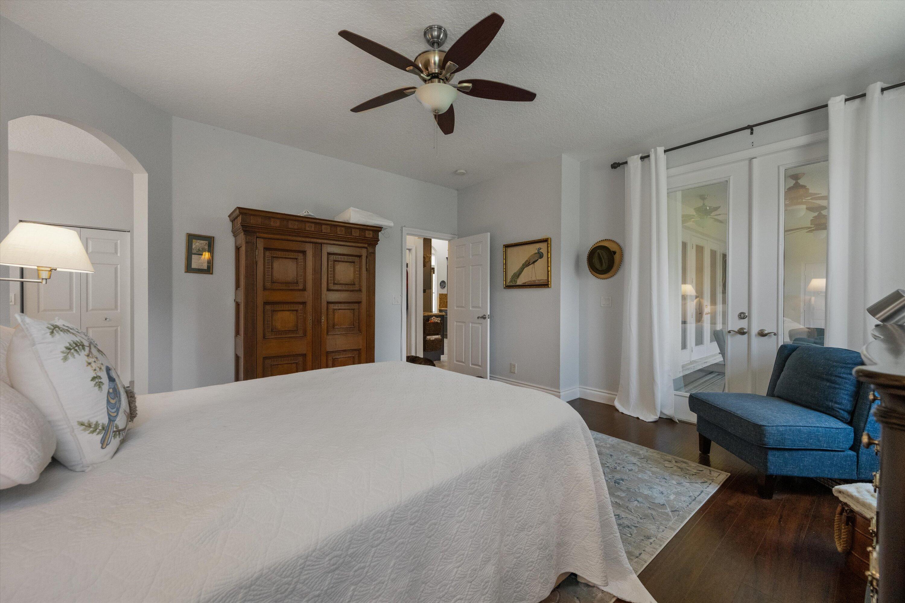 19986 Black Falcon Road Loxahatchee, FL 33470 - Photo 43 of 105 a bedroom with a bed a couch and a large window