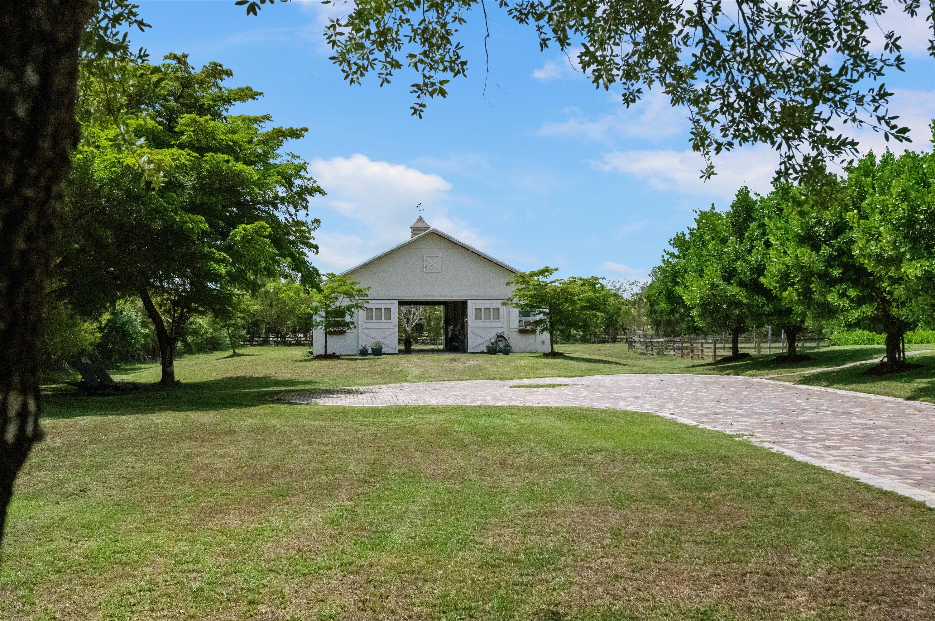 19986 Black Falcon Road Loxahatchee, FL 33470 - Photo 75 of 105 a front view of a house with a yard