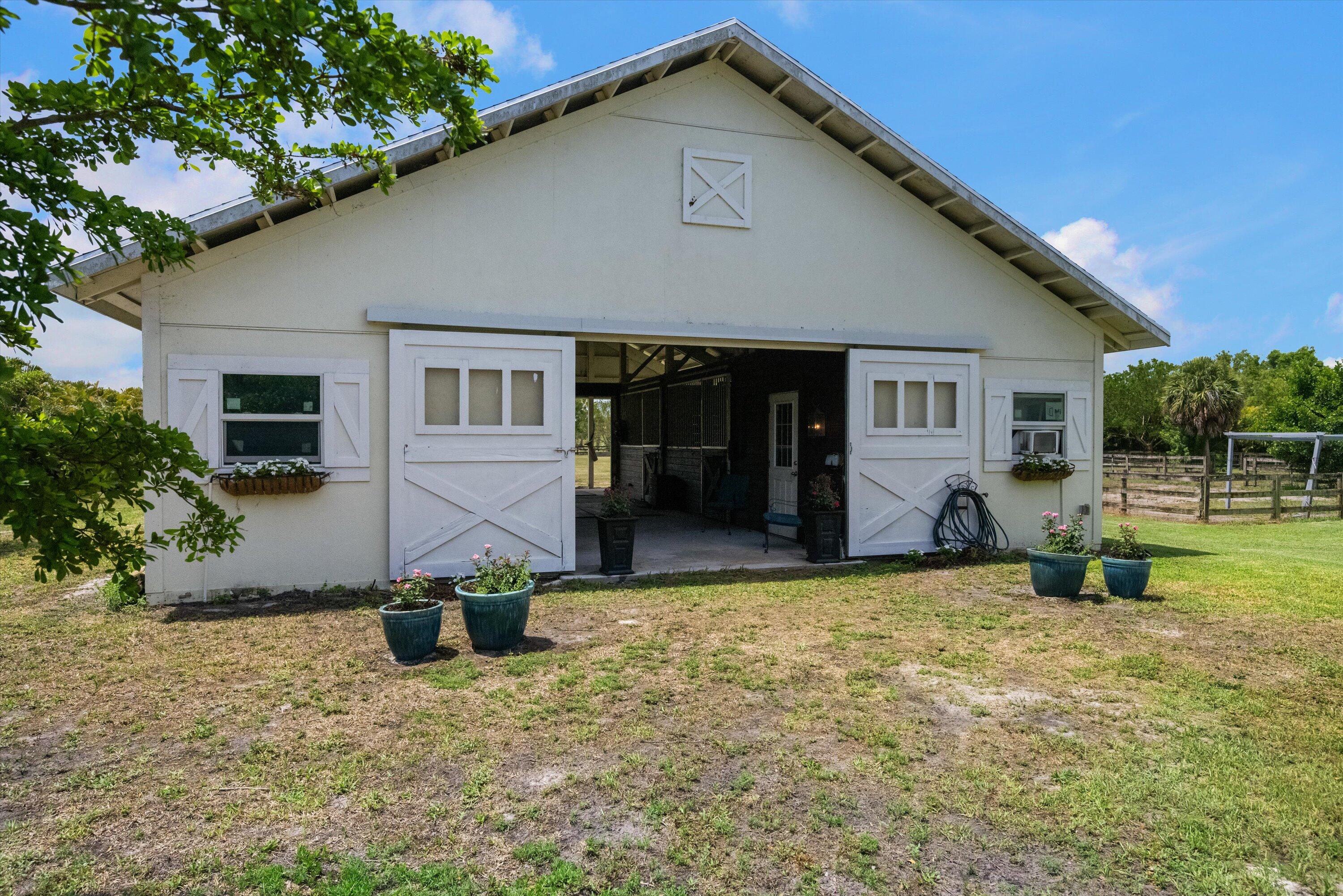 19986 Black Falcon Road Loxahatchee, FL 33470 - Photo 79 of 105 a view of a house with a yard
