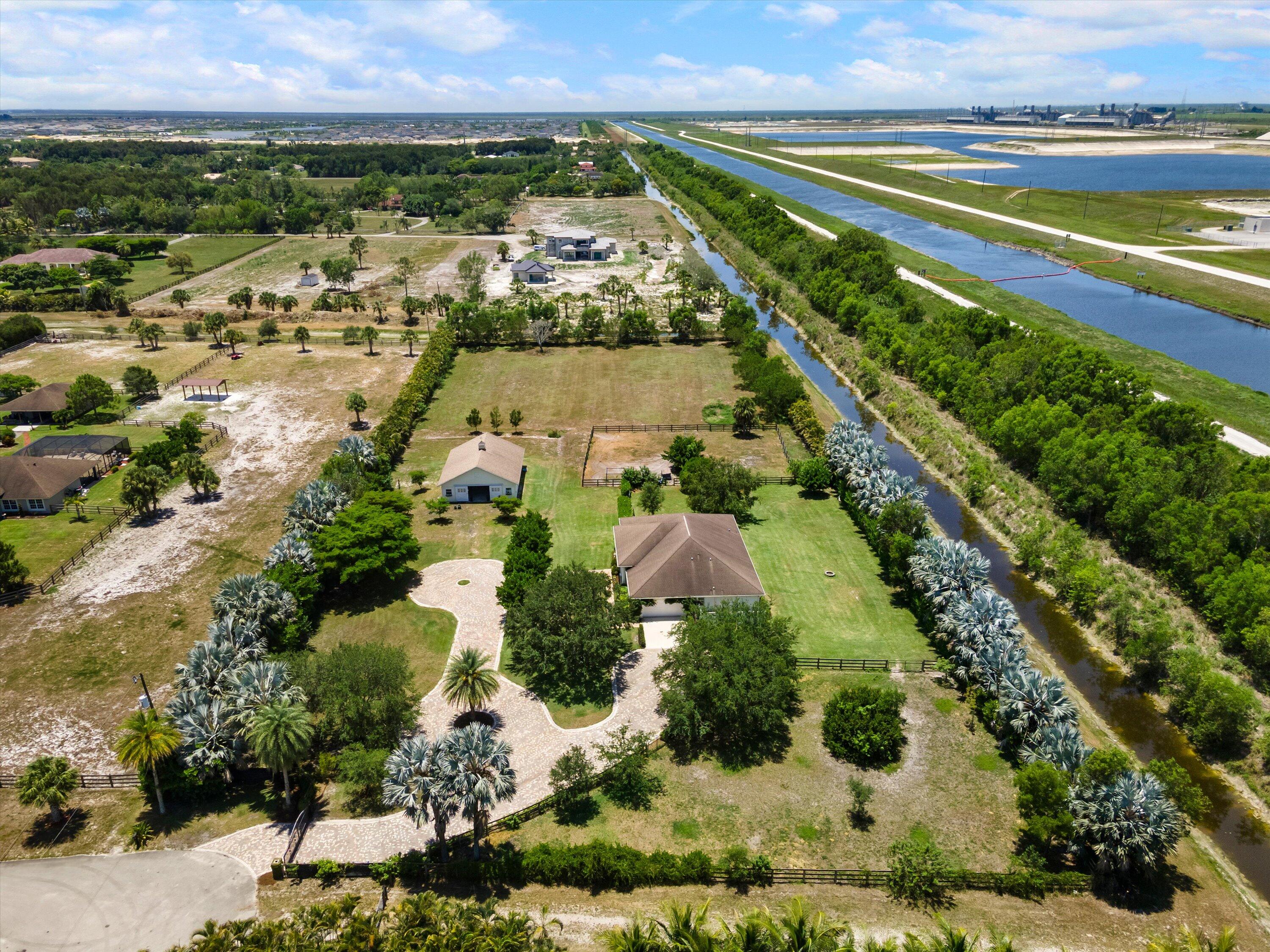 19986 Black Falcon Road Loxahatchee, FL 33470 - Photo 100 of 105 an aerial view of residential houses with outdoor space and street view